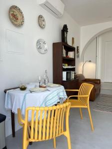 a dining room with a table and two chairs at Casa Alta T0 in Castelo de Vide