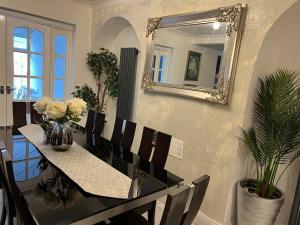 a dining room with a table and a mirror at Contractors accommodation near John Lennon Airport in Liverpool