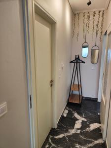 a hallway with a white door and a ladder at Olivia Apartment-Private parking in Chalkida