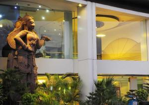 a statue of a man in front of a building at Hotel Palm Do'r Near New Delhi Railway Station in New Delhi