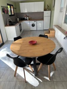 a wooden table and chairs in a kitchen at Chalet nature proche plage in La Ciotat