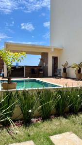 a house with a swimming pool in a yard at Ap em barra grande c/ piscina in Marau