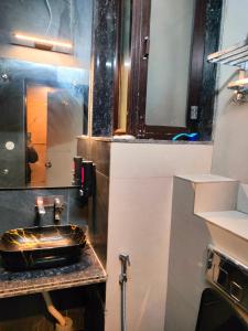 a bathroom with a sink and a mirror at Hotel Prem Shanti Inn in Dhaulpur