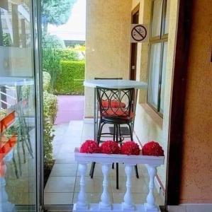 a table with red balls sitting on a porch at Keeme-Nao Self Catering Apartments in Gaborone