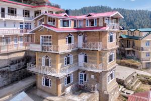 an overhead view of a building with balconies at Agro Stone Cottage & Cafe in Mashobra