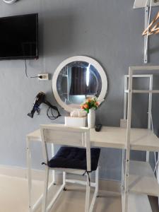 una scrivania bianca con sedia e specchio di 888 private room family a Mu Si