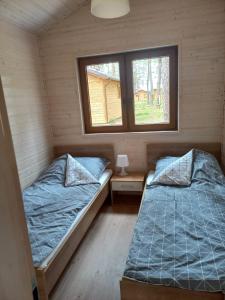 A bed or beds in a room at Wypoczywanko Domek 43, 45