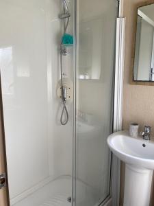 a bathroom with a shower and a sink at Lancaster Crescent Hot Tub Hideaway in Tattershall