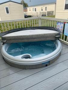 a hot tub on the deck of a house at Lancaster Crescent Hot Tub Hideaway in Tattershall