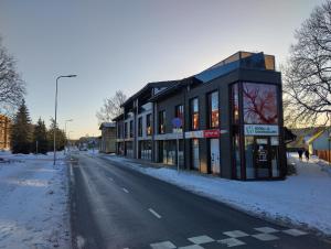 a building on the side of a snowy street at Suur-Aia 21 Apartment in Paide