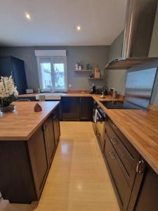 a large kitchen with wooden counters and a wooden floor at "Ô Tour's Angels" A Côté in Tours