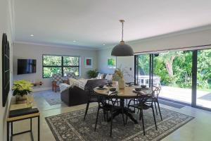 a living room with a table and a couch at Saffron House in Hermanus