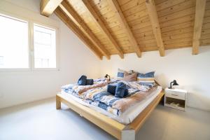 a bedroom with a bed with a wooden ceiling at Chasa Stradun 400 in Scuol