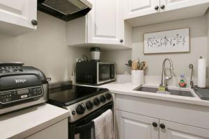 a kitchen with a stove and a microwave at Downtown WPB studio D - w full kitchen in West Palm Beach +22 photos
