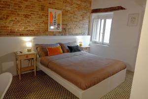 מיטה או מיטות בחדר ב-CASA NINETTA GUEST HOUSE