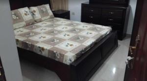 a bed in a bedroom with at Shahed Apartment in Amman