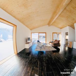 a living room with a couch and a chair at 3 bedroom condo in front of Obersaxen ski resort in Obersaxen