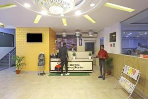 two men standing in a lobby of a store at Hotel Aeroporto Near By Delhi International Airport in New Delhi