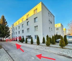 a building with two red arrows in front of it at Relax Apartment 2 in Sighişoara +5 photos