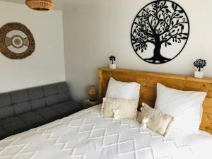 ein Schlafzimmer mit einem Bett mit einem Baum an der Wand in der Unterkunft Gastenkamer met jacuzzi in de Vlaamse Ardennen in Brakel