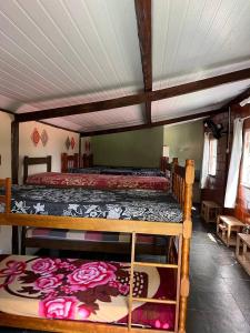 a bedroom with two bunk beds with roses on them at HOSTEL DAS ESTRELAS in Areal