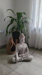 a statue of a woman sitting on the floor at Casa Buda in Almafuerte