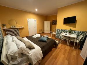 a bedroom with a bed and a desk and a television at Casina Dei Marsi in Avezzano