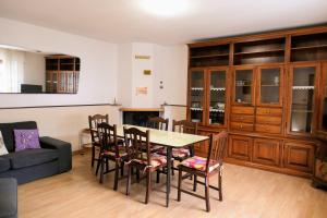 a living room with a table and chairs and a couch at Casa Ezio in Malesco