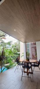 a dining room with a table and chairs on a patio at Sweet Tulum 202 in Tulum