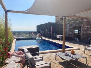 a patio with a swimming pool with a table and chairs at Belle villa en Provence in Lançon-Provence