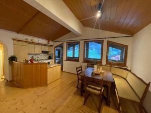 a kitchen and dining room with a table and chairs at homy Alpine Deluxe Chalet in St Anton im Montafon in Sankt Anton im Montafon