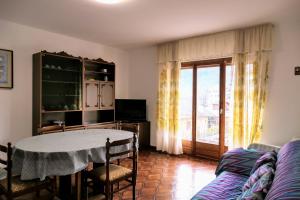 a living room with a table and a couch at Casa Ezio - Piano terra in Malesco