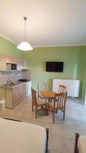 a kitchen and dining room with a table and chairs at House Eugenia Sarti in Sarti