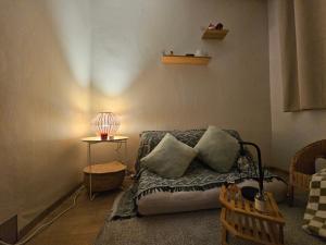 a living room with a couch with pillows and a lamp at Romantic sillim in Seoul