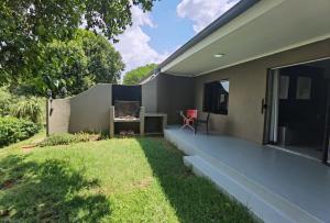 a backyard of a house with a lawn at Brae Allen in Hartbeespoort