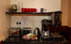 a kitchen counter with a coffee maker on a counter top at St Mark Hotel in London