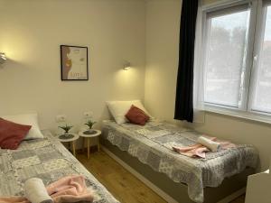 a bedroom with two beds and a window at City Center Suite Novalja in Novalja