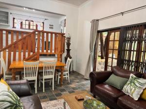a living room with a couch and a table at Aurora Bushbaby 2 in Centurion