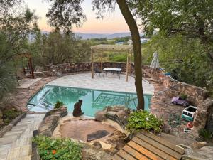 a swimming pool in a yard with a table at Aurora Bushbaby 2 in Centurion