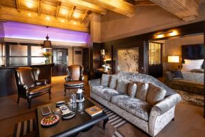 a living room with a couch and a table at Le Lana in Courchevel