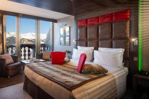 a bedroom with a large bed with a mountain view at Le Lana in Courchevel