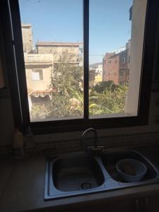 a kitchen sink and a window with a view at Maison de vacances in Tabarka