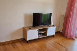a flat screen tv sitting on top of a cabinet at An apartment located at nature with 2.5 rooms in Düsseldorf