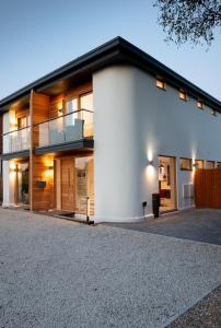 a white building with a balcony on it at King Bed Joy Lane, Chichester near Goodwood in Chichester