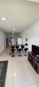 a living room with a table and black chairs at Pousada e Casa Praias de Penha in Penha +7 photos