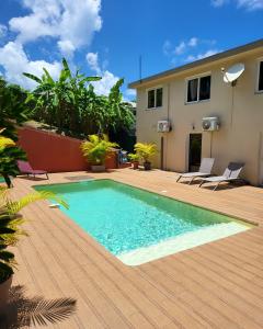 a swimming pool on the deck of a house at Résidence Belle Anse 4 Pers 3ilets in Les Trois-Îlets