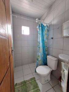 a small bathroom with a toilet and a sink at Casa de Avinha in Sirinhaém +19 photos