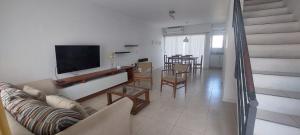 a living room with a couch and a tv and a table at Caireles del Carnaval in Gualeguaychú
