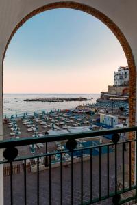 a view of a beach with chairs and umbrellas at La Piccola Atrani in Atrani