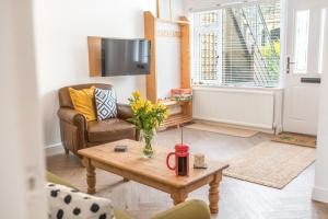 a living room with a coffee table and a couch at Couples getaway in central Windermere, ground floor flat with parking in Windermere